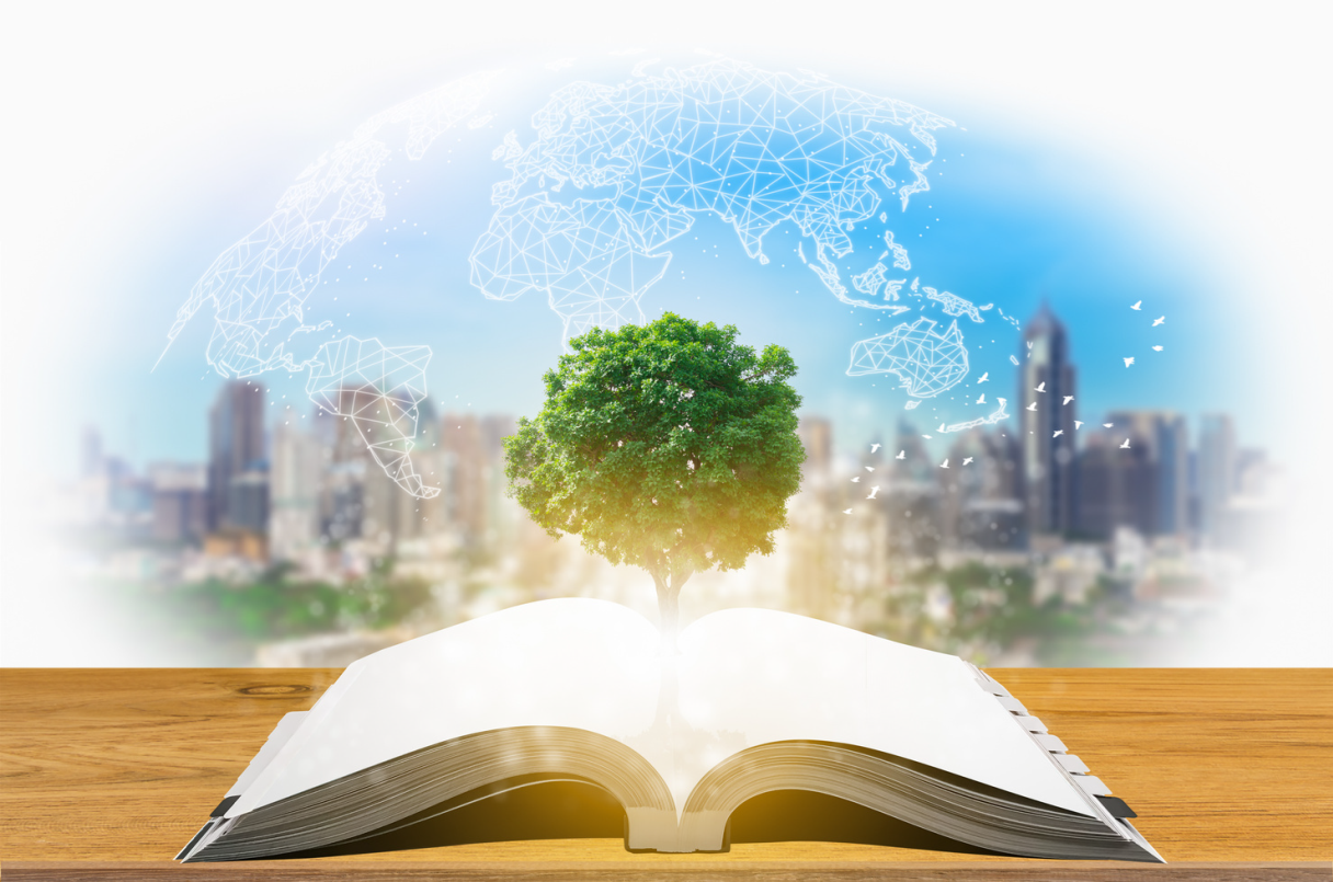Open book with a living tree city scape and globe